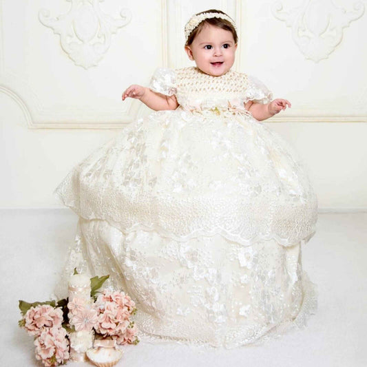 elegant white baby baptism gown with silver embroidered details and floral waist accent