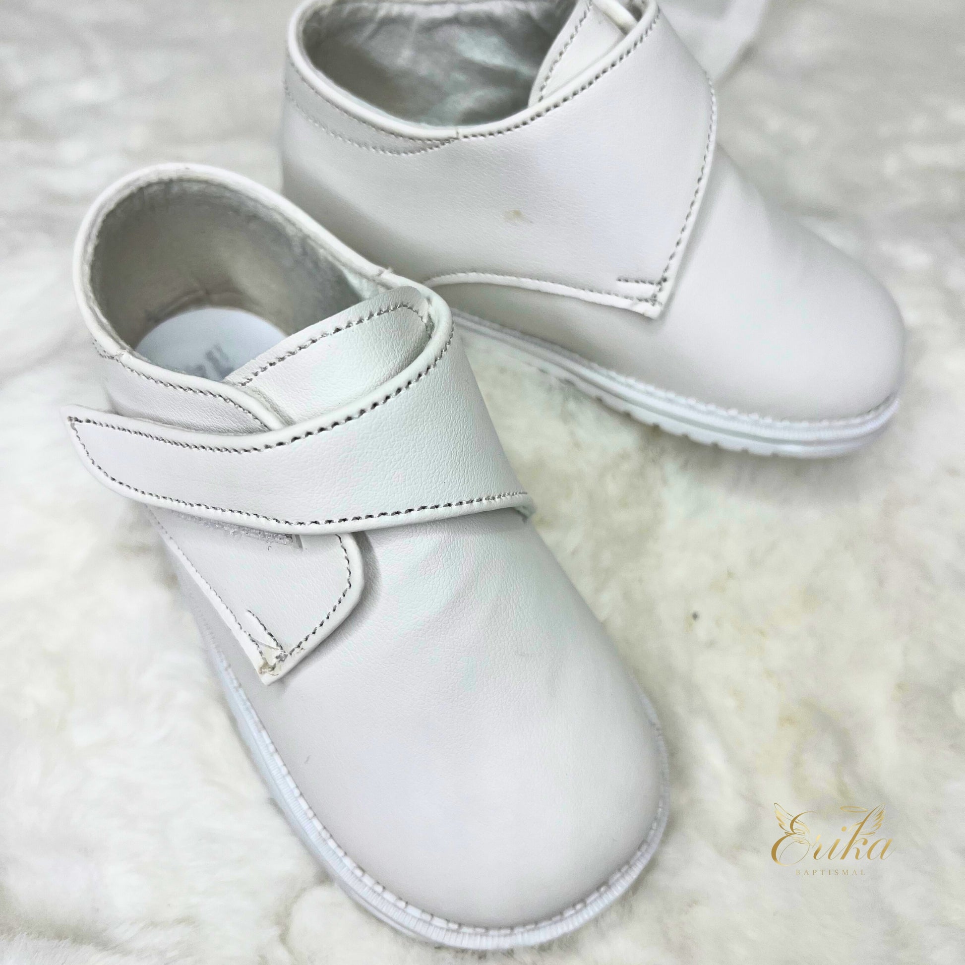 simple white baby boy baptism shoes with minimal design and soft material