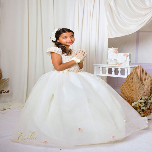 Front view of a white First Communion dress with a voluminous tulle skirt and a cluster of 3D flowers at the waist