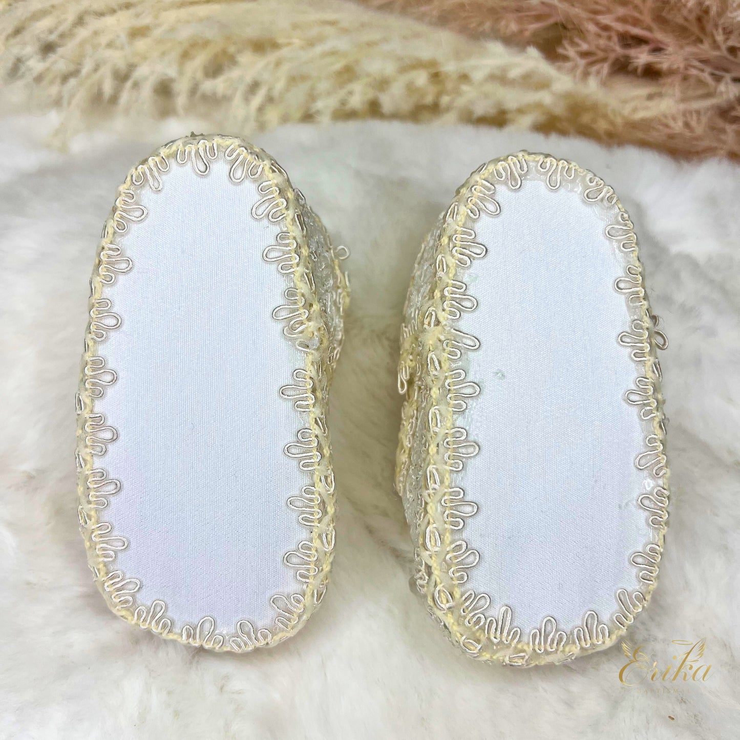 white baby christening shoes with floral design and soft comfortable material