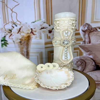 Complete baby baptism set including a decorated white candle, shell, and lace-trimmed drying towel