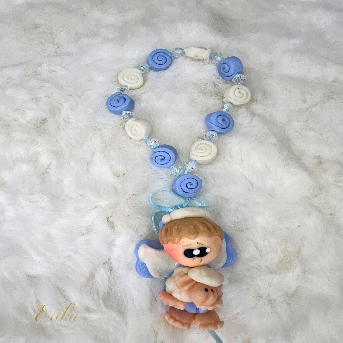 Blue cold porcelain angel favor in a white tulle bag by Erika Baptismal