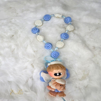 Blue cold porcelain angel favor in a white tulle bag by Erika Baptismal