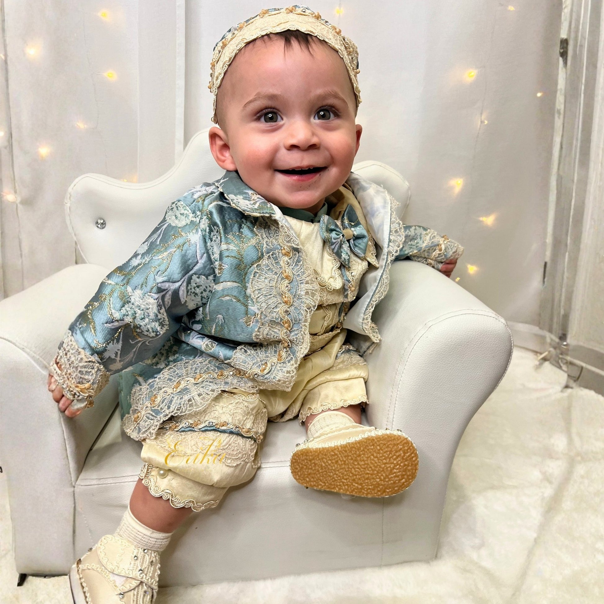 elegant baby boy baptism outfit in blue and pearl with lace details and soft refined fabric