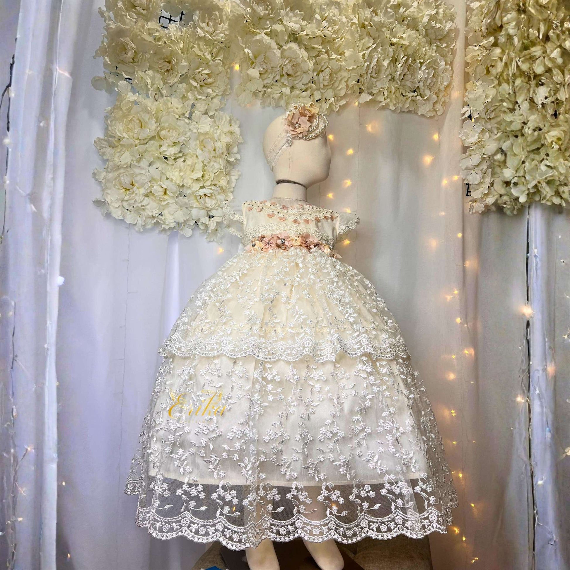 elegant long baby baptism dress with lace ruffles and floral waist accent in delicate soft fabric