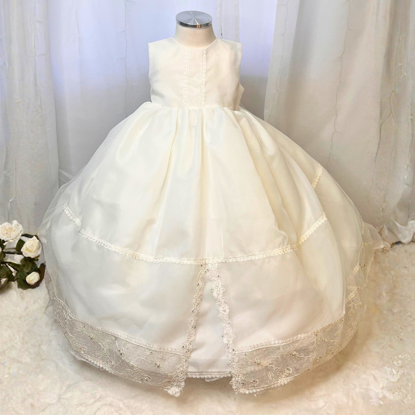 White baby christening dress with floral embroidery and soft delicate fabric
