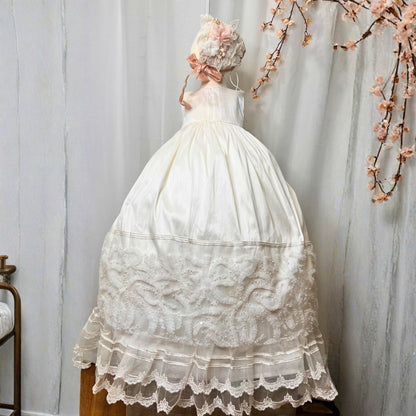 elegant baby baptism dress with layered ruffles and floral embroidery in soft fabric
