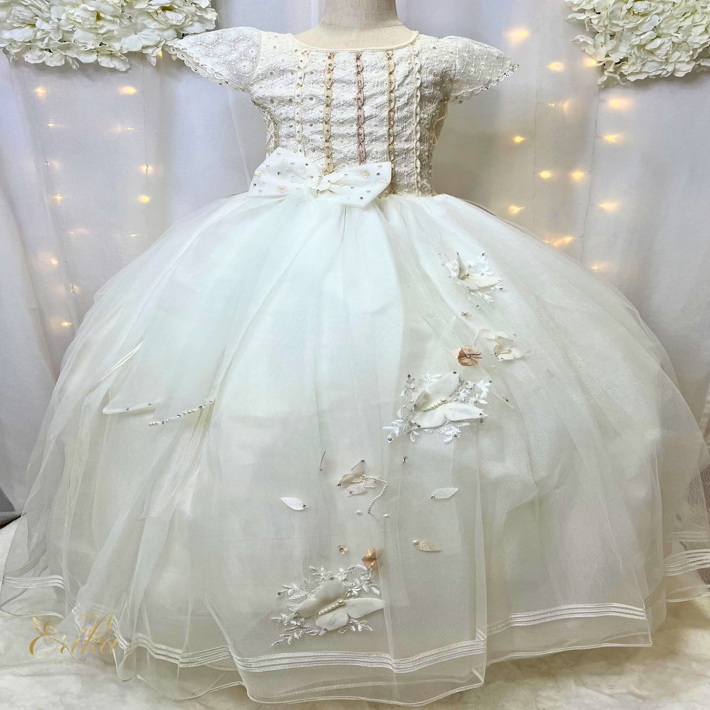 Gold-threaded embroidery and 3D butterflies on a pearl Communion dress