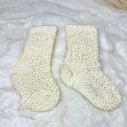 Ivory knee-high baptism socks with traditional pointelle stitching for infant girls