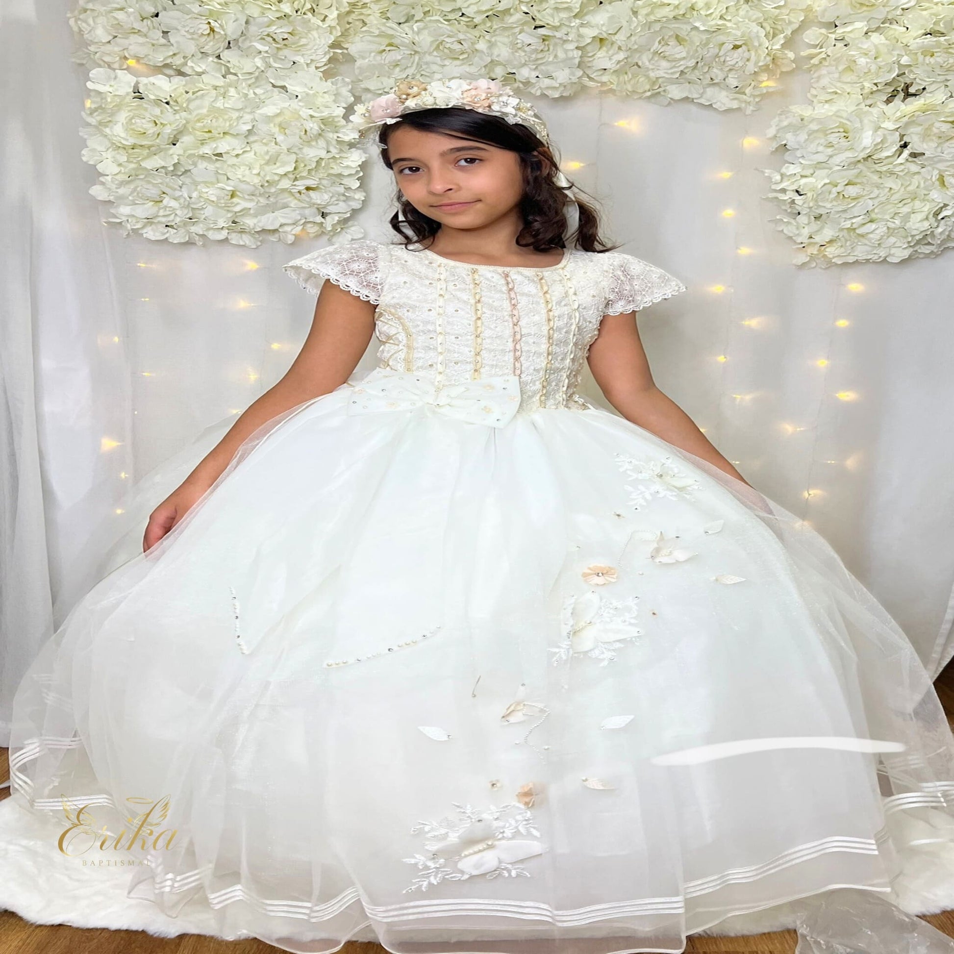 Exquisite pearl communion dress featuring a jeweled bodice with gold and crystal accents.