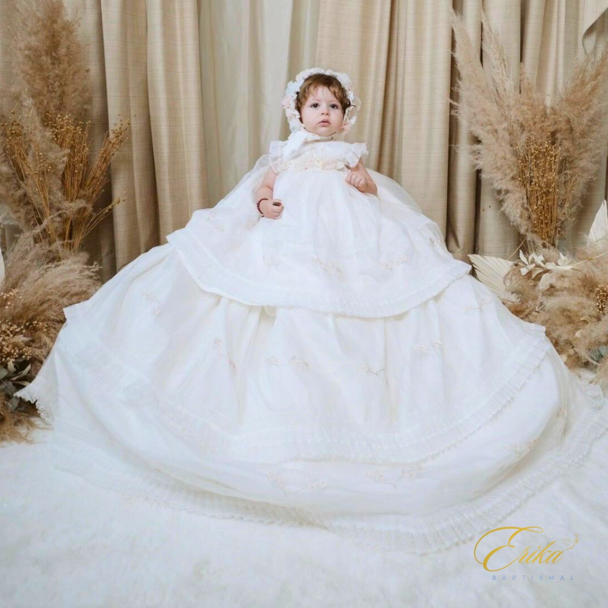long modern white baby christening dress with subtle floral embroidery and light tulle at the bottom