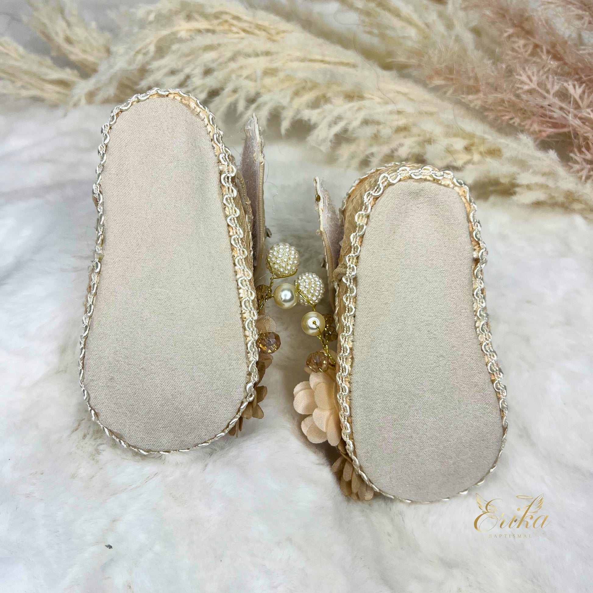 Pearl christening shoes for baby girls with 3D floral appliqués and soft soles.