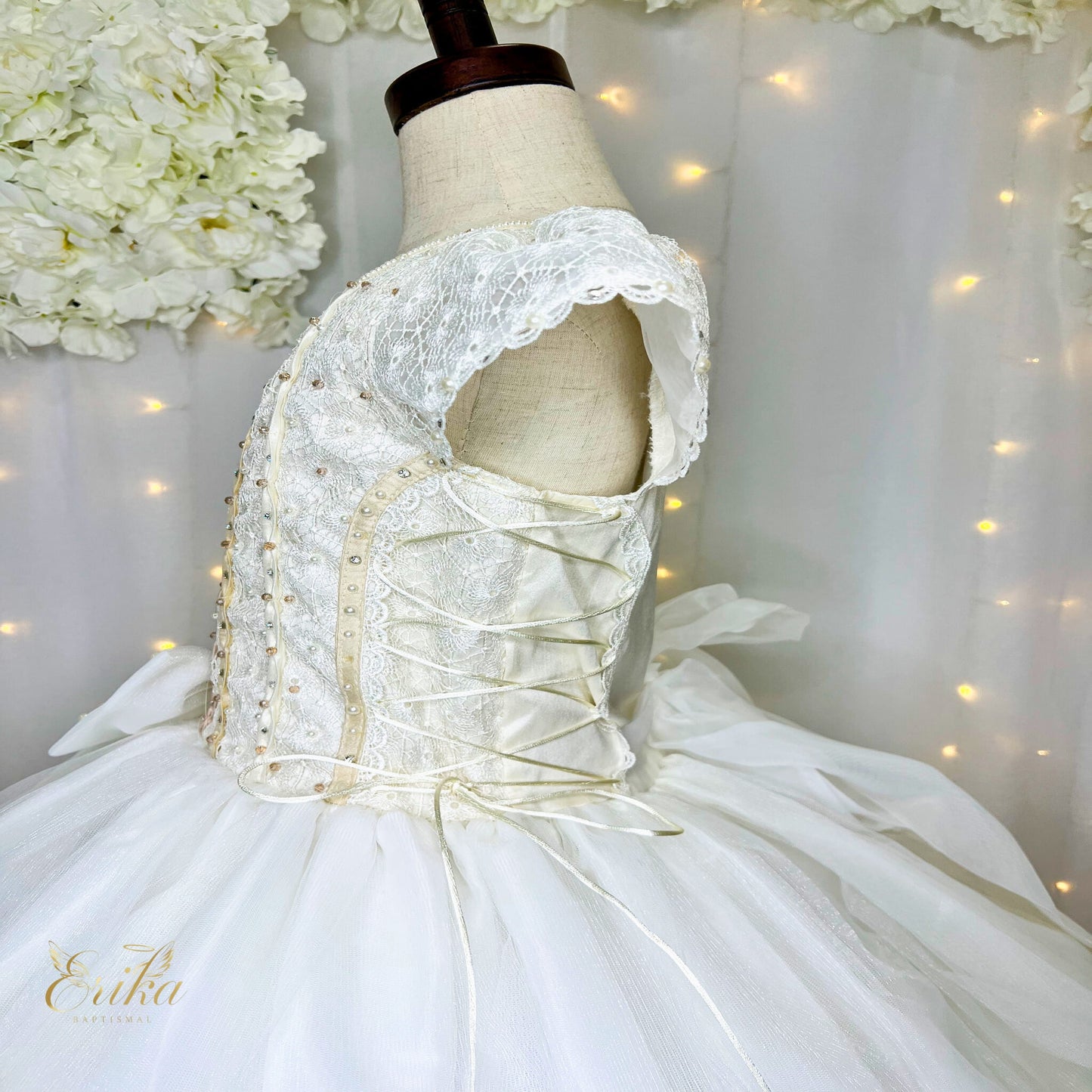 Detailed floral petals and 3D butterflies on a luxury pearl Communion gown
