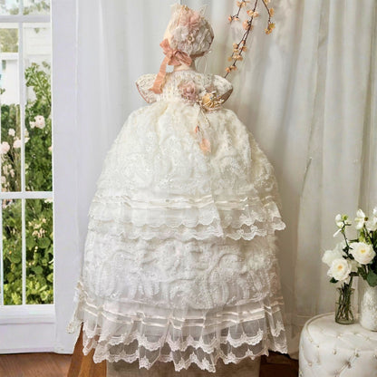 baby christening dress with ruffles and floral details made with soft elegant fabric